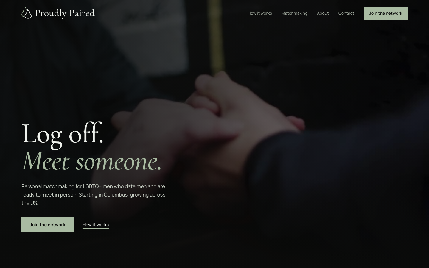 Proudly Paired homepage with the headline “Log off. Meet someone.” over a dark photo of clasped hands.